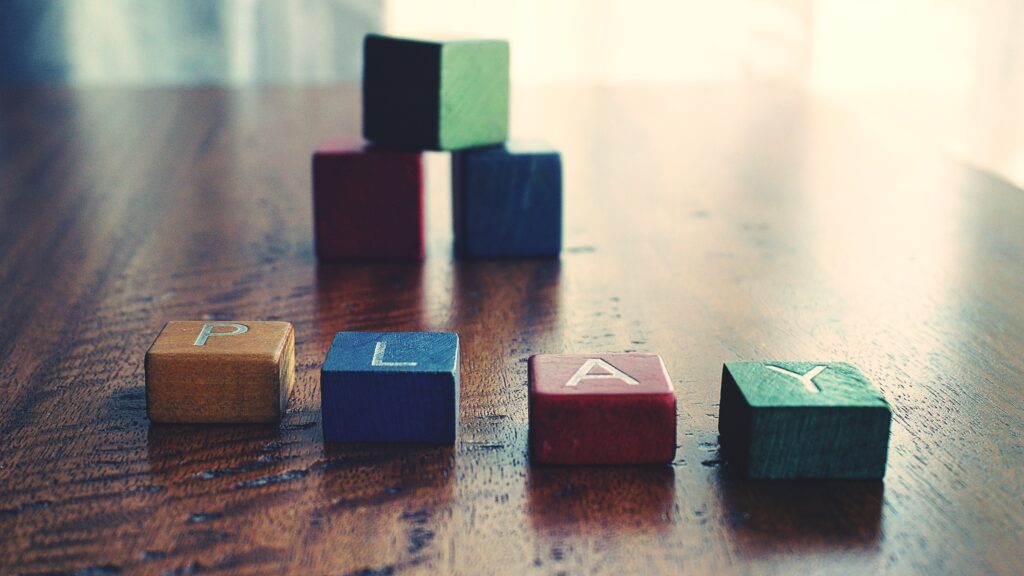 colorful blocks spelling out the word "play"