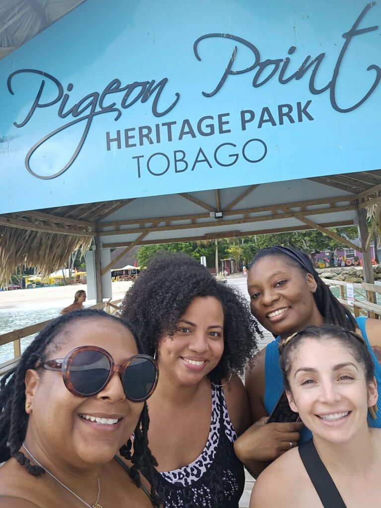 four participants in sandtray retreat smiling at the beach
